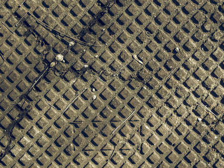 Vintage looking Detail of a rusted steel manhole backgroundの写真素材