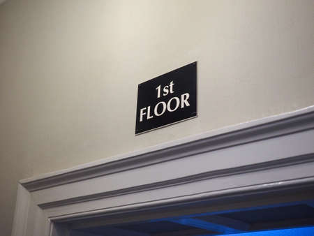 Door with 1st floor label in hotel interiorの写真素材