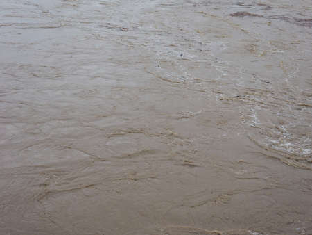 Brown muddy water surface useful as a backgroundの写真素材