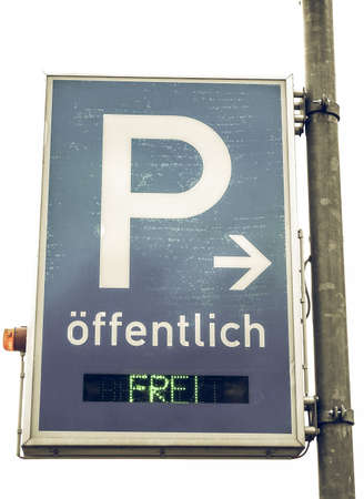 Vintage looking A road sign for a parking area - Oeffentlich means publicの写真素材