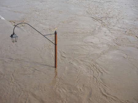 Street Lamp on Murazzi bank of River Po submerged in water due to flood in city centre in Turin, Italyの写真素材
