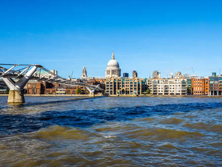 LONDON, UK - SEPTEMBER 28, 2015: People crossing the Millennium Bridge over River Thames linking the City of London with the South Bank between St Paul Cathedral and Tate Modern art gallery (HDR)のeditorial素材