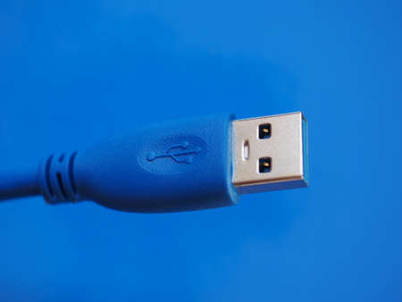 USB plug for computer over blue background