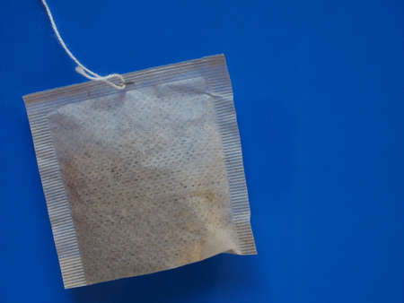 tea bag over a blue background with copy spaceの写真素材