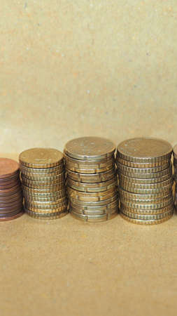 Pile of Euro coins currency of the European Union - selective focus on coins with blurred background copy space - verticalの写真素材