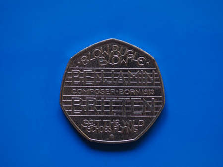 Twenty Pence coin money (GBP), currency of United Kingdom over blue backgroundの写真素材