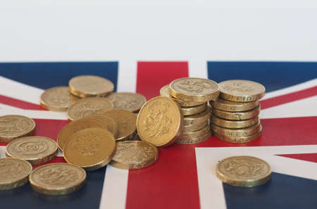 Pound coins money (GBP), currency of United Kingdom, over the Union Jackの写真素材