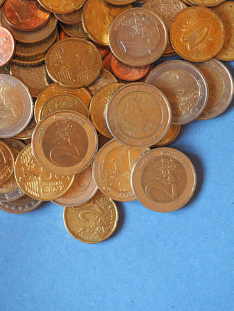 Euro coins money (EUR), currency of European Union over blue background with copy space