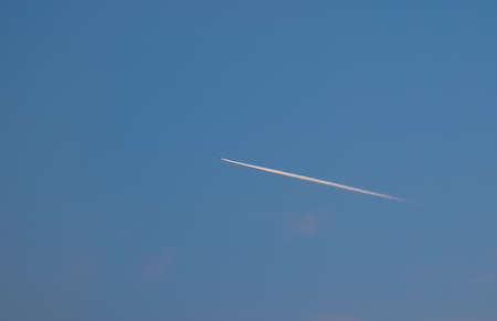 plane trail over the blue sky background