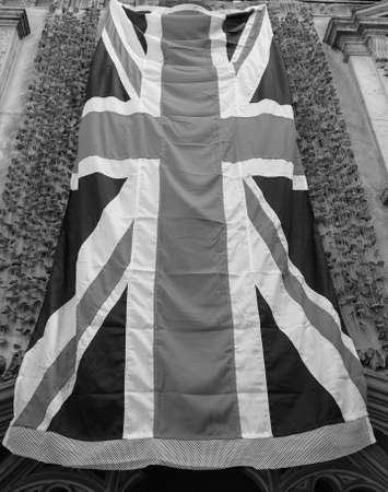 BRISTOL, UK - CIRCA SEPTEMBER 2016: Union Jack with remembrance poppy artificial common field popp flower used since 1921 to commemorate military personnel who have died in war in black and whiteのeditorial素材