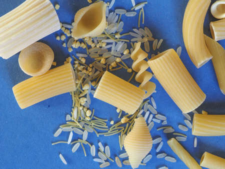Many different kinds of Italian pasta including penne macaroni (maccheroni) fusilli spaghetti trenette (linguine) orecchiette tortiglioni conchiglie (shells) rice and egg pastaの写真素材