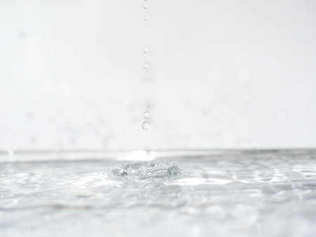 stream of water flowing from a faucetの写真素材