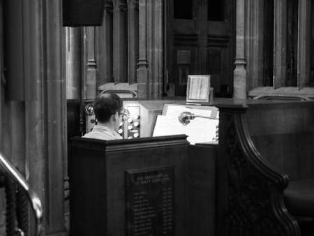 BRISTOL, UK - CIRCA SEPTEMBER 2016: Organist at St Mary Redcliffe Anglican parish church in black and whiteのeditorial素材