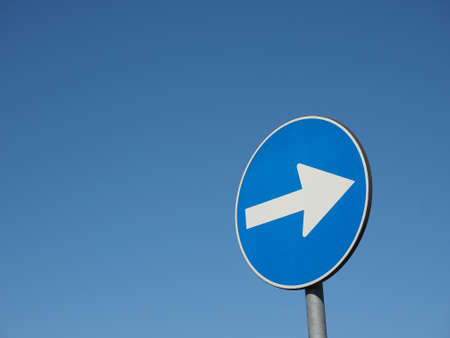 Regulatory signs, proceed in direction indicated by arrow traffic signの写真素材
