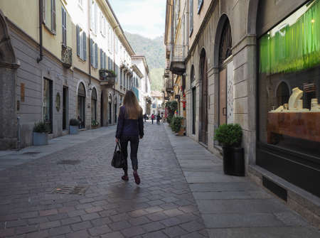 COMO, ITALY - CIRCA APRIL 2017: Girl walking in the old city centreのeditorial素材