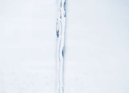 stream of water flowing from a faucetの写真素材