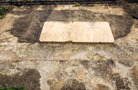 ancient weathered concrete wall with blank plaque, copy space to type your own text (HDR)の写真素材
