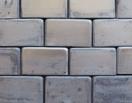 grey metal brick wall useful as a backgroundの写真素材