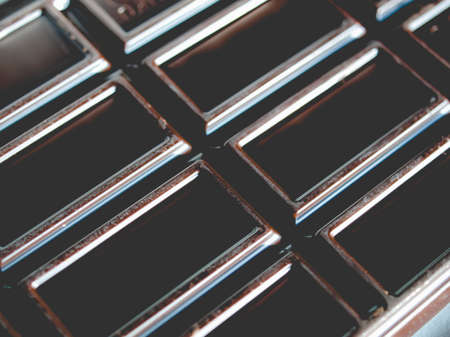 Detail of a dark chocolate tablet food, vintage faded lookの写真素材