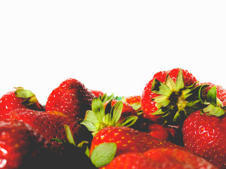 Detail of strawberries isolated over white with copy space, vintage faded lookの写真素材