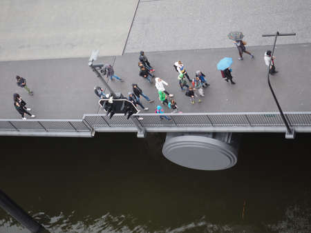 HAMBURG, GERMANY - CIRCA MAY 2017: A crowd of people crossing Am Kaiserkai bridgeのeditorial素材