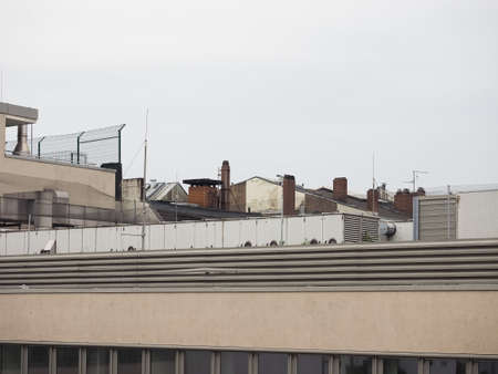 urban skyline with roof chimneys and air conditioning units and aerials