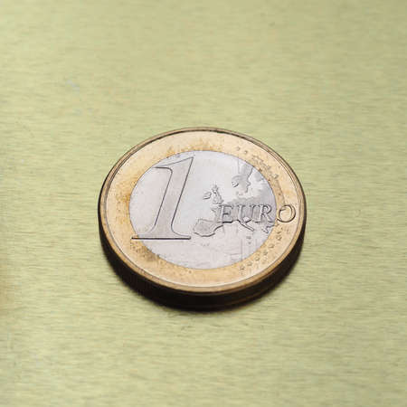 1 euro coin money (EUR), currency of European Union over golden background with reflectionの写真素材