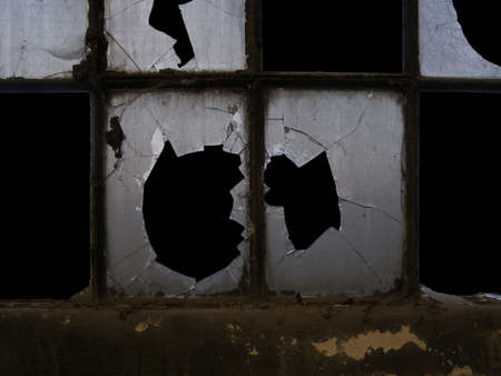 old industrial window with broken glass, dark black night skyの写真素材