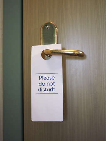 please do not disturb sign on hotel room doorの写真素材