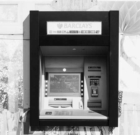 LONDON, UK - CIRCA JUNE 2017: Barclays bank invented Automated Teller Machine (ATM) in 1967. It is now widely used worldwide in black and whiteのeditorial素材
