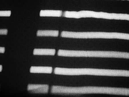 sun shining through window blinds in a roomの写真素材