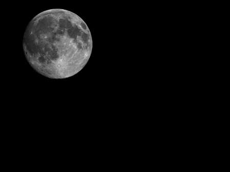 Full moon seen with an astronomical telescope with copy spaceの写真素材