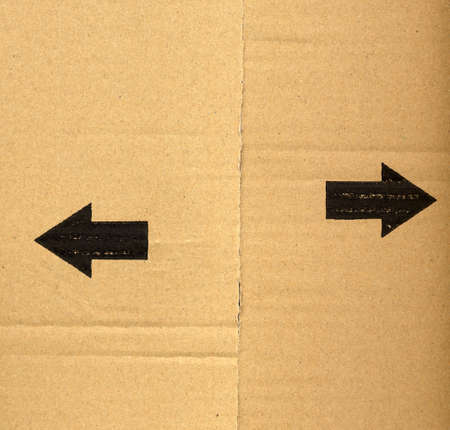 black left and right arrow on corrugated cardboard packetの写真素材