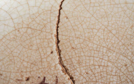 cracked brown ceramic texture useful as a backgroundの写真素材