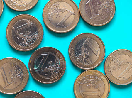 1 euro coins money (EUR), currency of European Union over green blue background