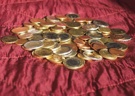 Euro coins money (EUR), currency of European Union over crimson red velvet backgroundの写真素材