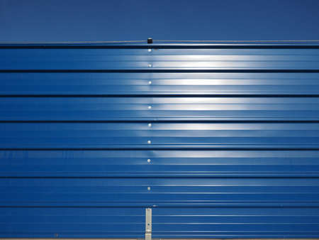 blue metal fence barrier over blue sky