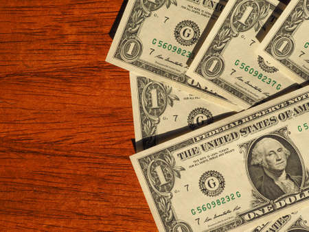 Dollar banknotes money (USD), currency of United States on wooden desk with copy spaceの写真素材