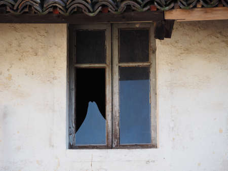 detail of old window broken glass paneの写真素材