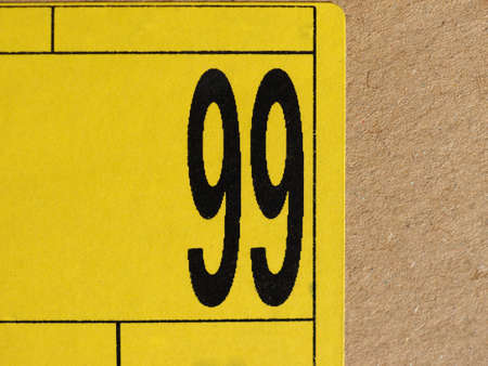 number 99 (ninetynine) printed in black on a yellow label