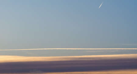 blue sky with plane vapour trails (aka contrails, short for condensation trails)