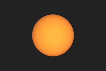 the Sun seen with telescope from planet Earth, with sunspots visible as dark spots compared to surrounding regionsの写真素材