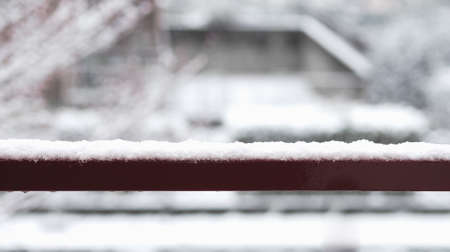 Snow on a handrail in cold winter seasonの写真素材