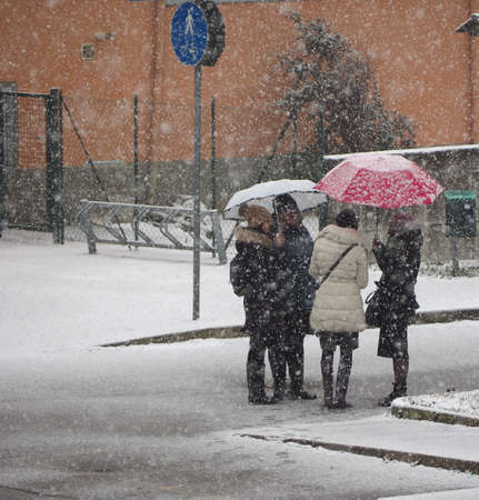 TURIN, ITALY - CIRCA MARCH 2018: Women with umbrella in the snow in exceptionally cold winter weatherのeditorial素材