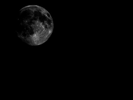 High contrast Full moon seen with an astronomical telescope with copy spaceの写真素材