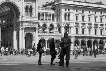 MILAN, ITALY - CIRCA APRIL 2018: People in Piazza Duomo in black and white