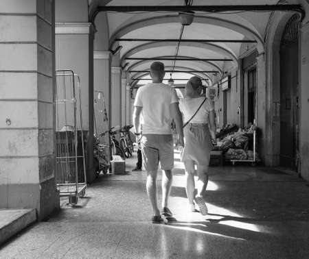 BOLOGNA, ITALY - CIRCA SEPTEMBER 2017: People in traditional colonnade porch (aka as portici) in black and whiteのeditorial素材