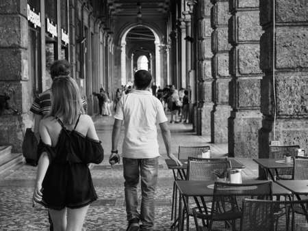 BOLOGNA, ITALY - CIRCA SEPTEMBER 2017: People in traditional colonnade porch (aka as portici) in black and whiteのeditorial素材