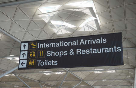 LONDON, UK - CIRCA JUNE 2018: International arrivals, shops and restaurants, toilets sign at Stansted Airportのeditorial素材