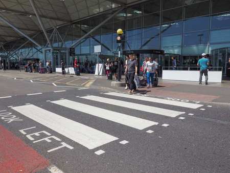 STANSTED, UK - CIRCA JUNE 2018: Travellers at London Stansted airport design by architect Lord...